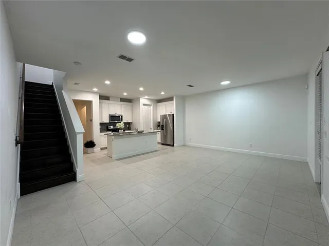 a kitchen with a refrigerator and a stove top oven
