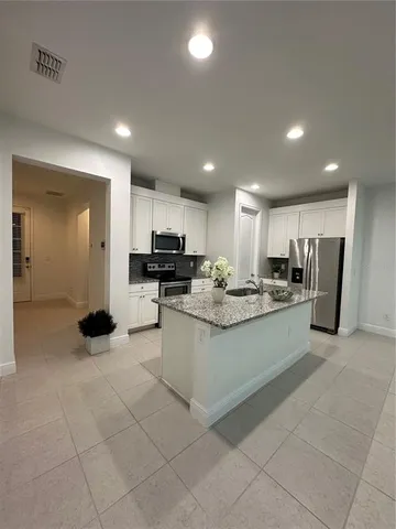 a kitchen with stainless steel appliances granite countertop a stove and a refrigerator
