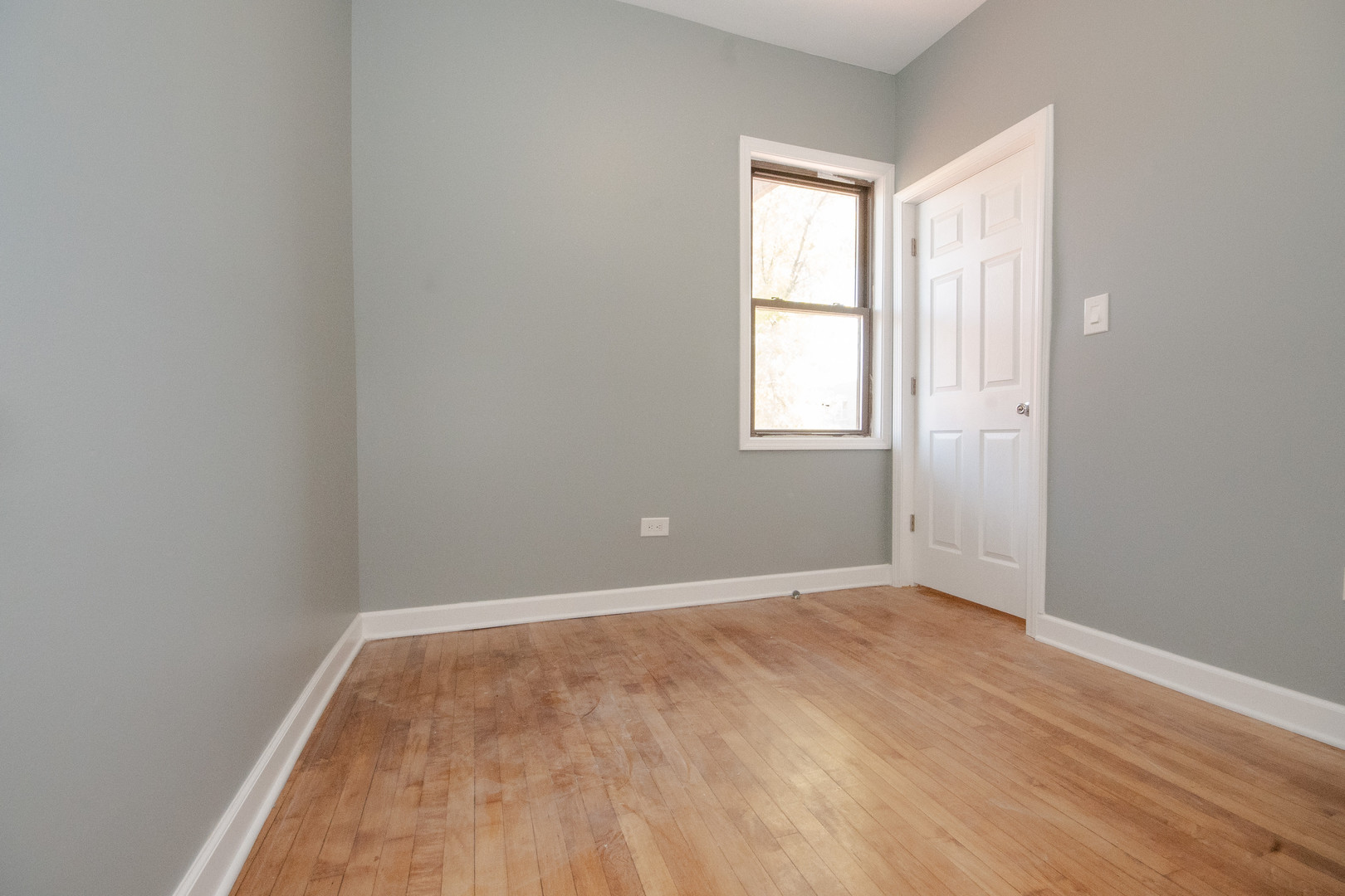 925 South Laflin Street, Unit 2R Chicago, IL 60607 - Photo 11 of 29 an empty room with wooden floor and windows