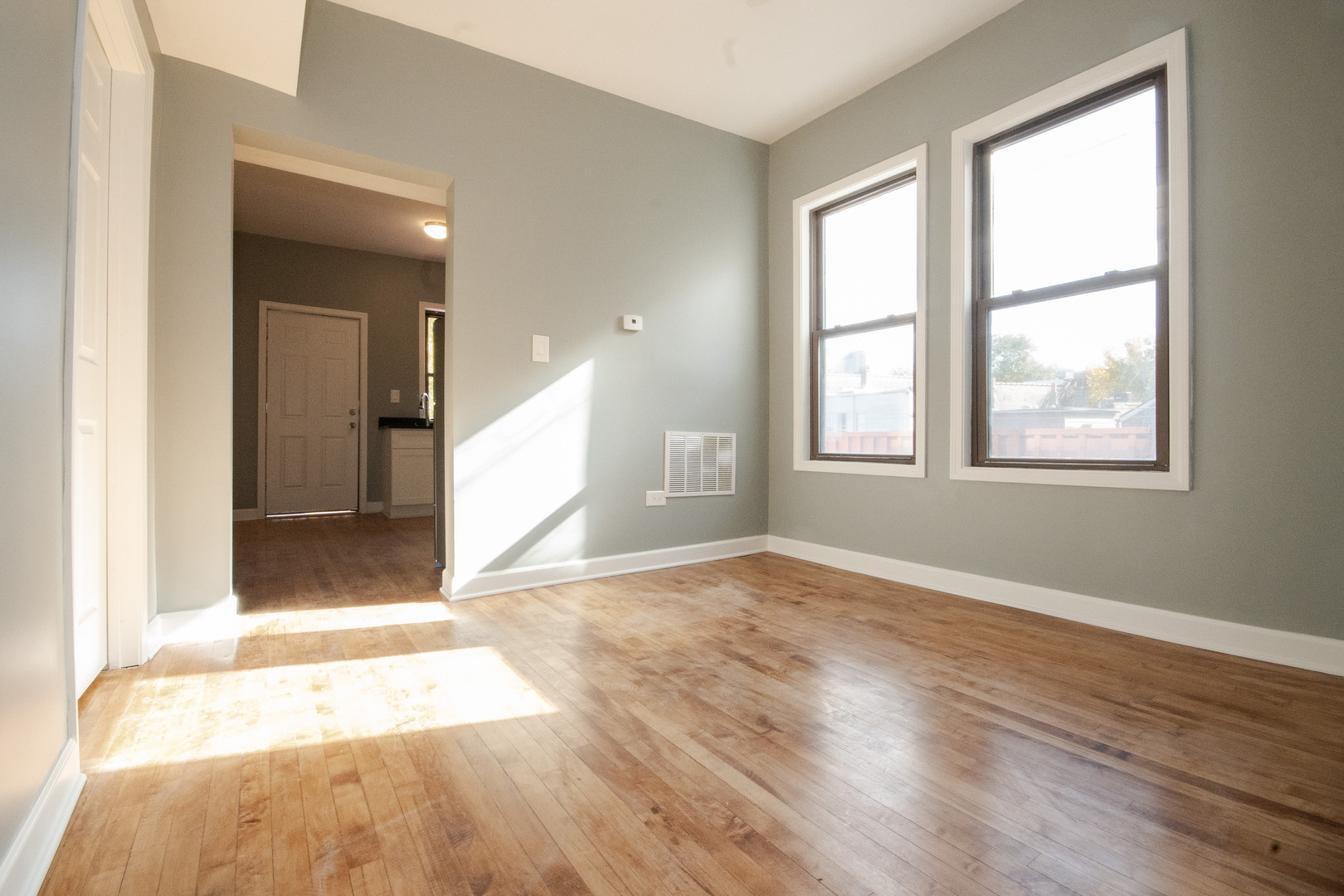 925 South Laflin Street, Unit 2R Chicago, IL 60607 - Photo 2 of 29 an empty room with wooden floor and windows