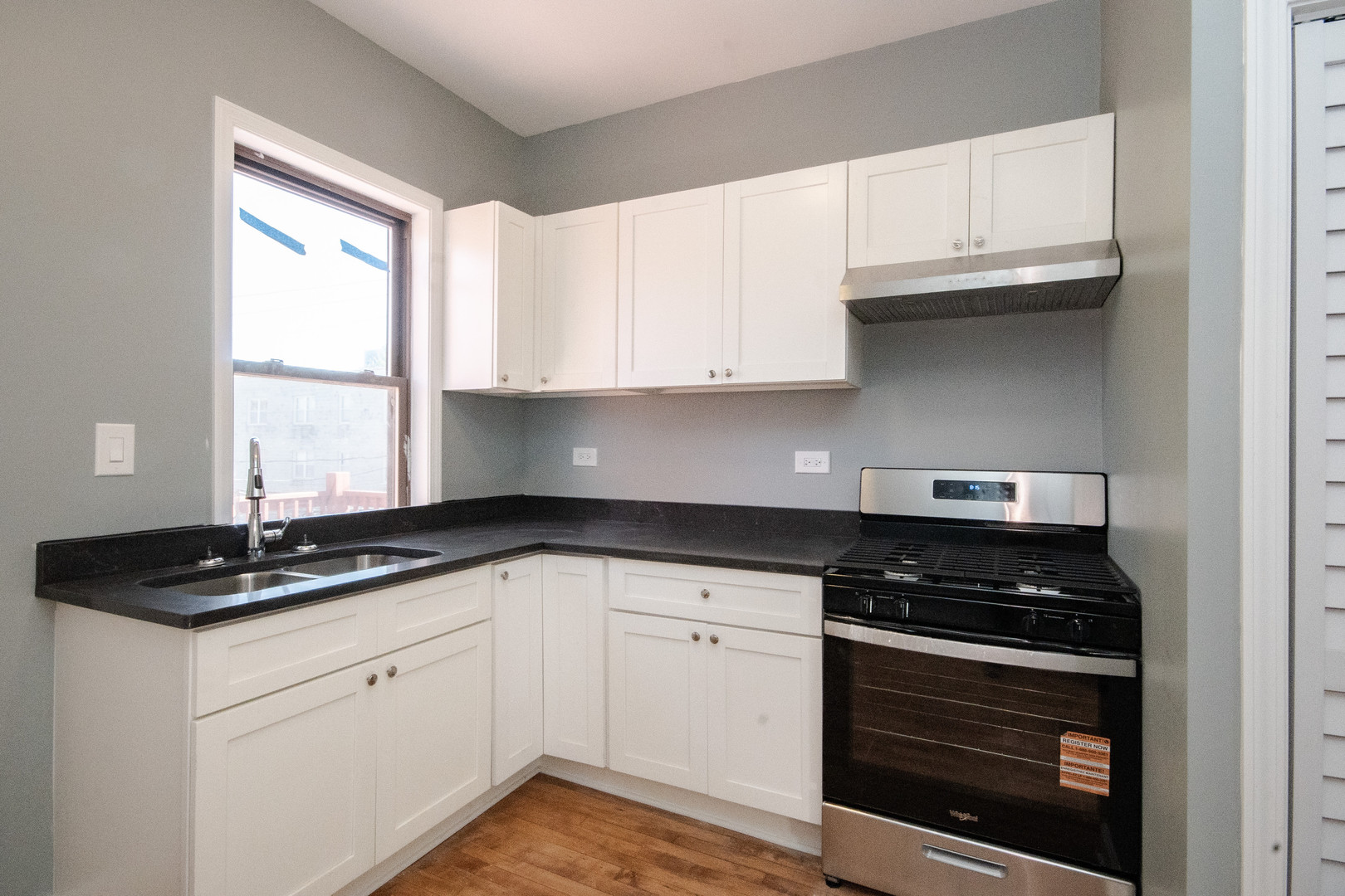 925 South Laflin Street, Unit 2R Chicago, IL 60607 - Photo 8 of 29 a kitchen with granite countertop white cabinets and black appliances
