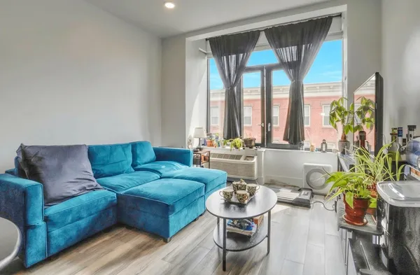 a living room with furniture and a large window