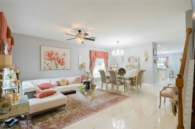 a living room with furniture and a chandelier