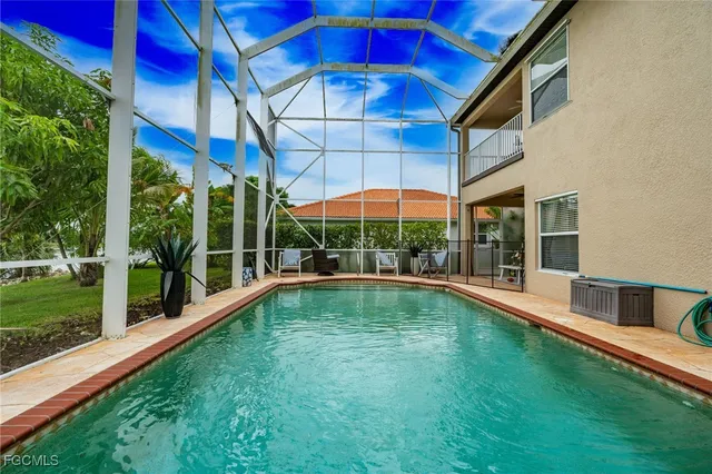an aerial view of a house with a garden and lake view