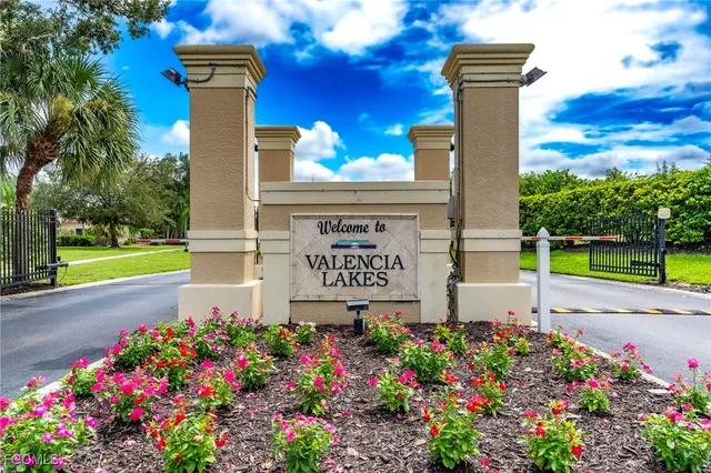 a sign that is sitting in front of flowers
