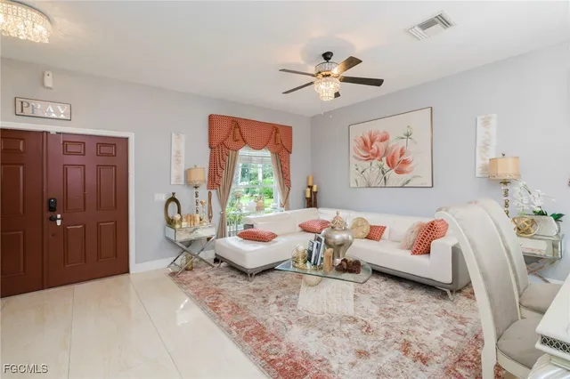 a living room with furniture and a chandelier