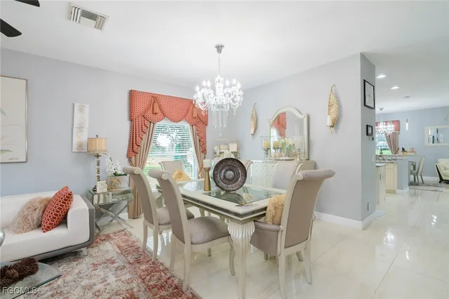 a view of a dining room with furniture and chandelier