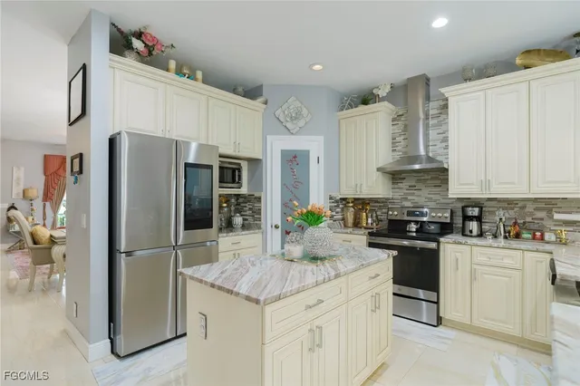 a kitchen with granite countertop a sink stainless steel appliances and cabinets