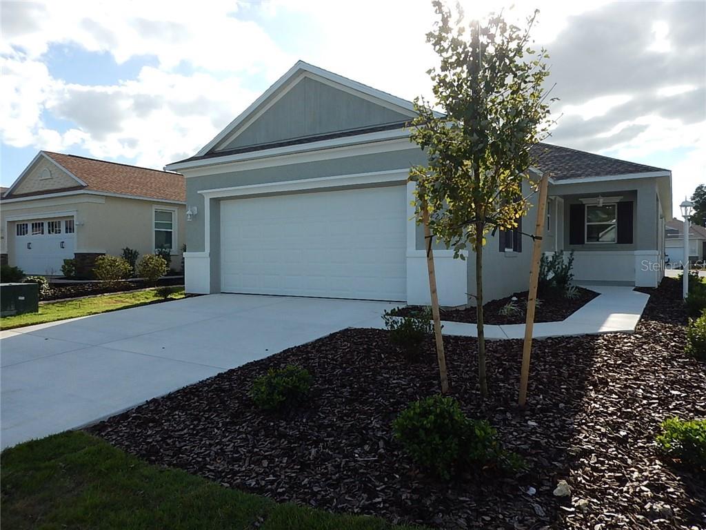 7722 Southwest 88th St Road Ocala, FL 34476 - Photo 1 of 1 a backyard of a house with table and chairs