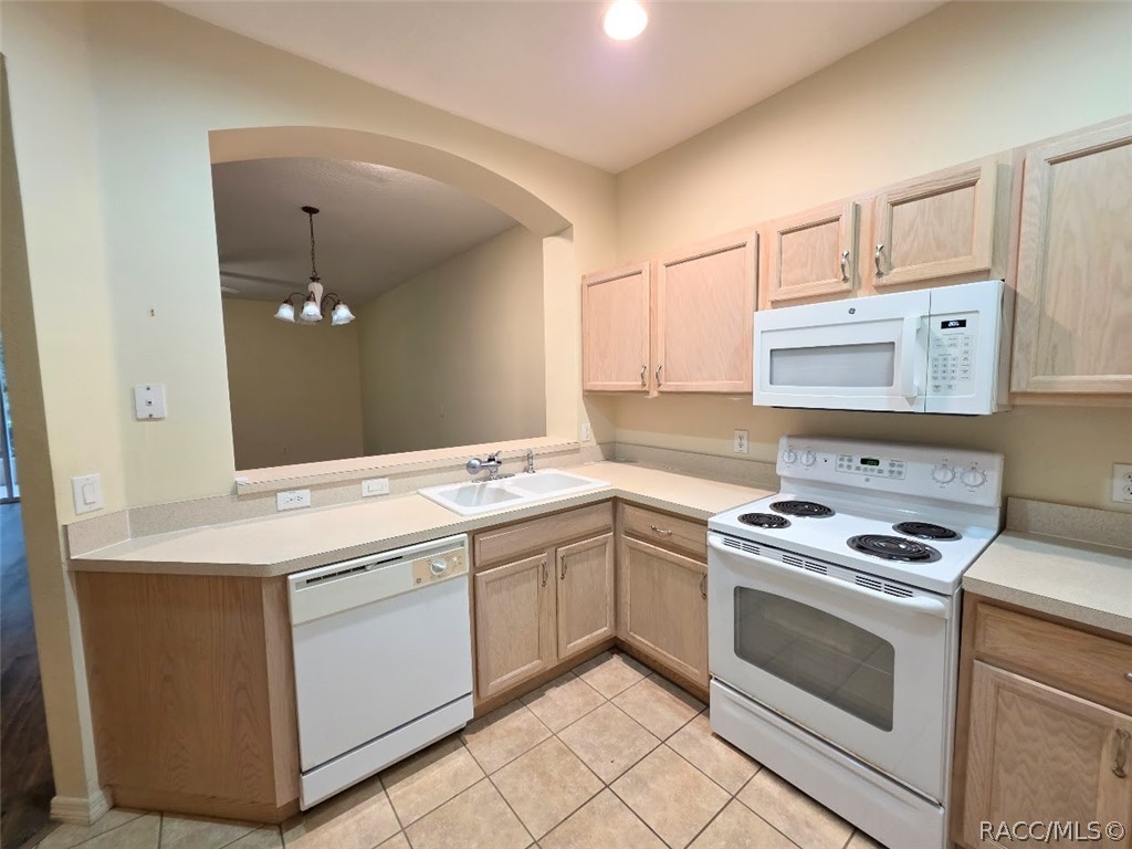 1600 West Spring Meadow Loop Lecanto, FL 34461 - Photo 10 of 28 a kitchen with a stove sink and cabinets