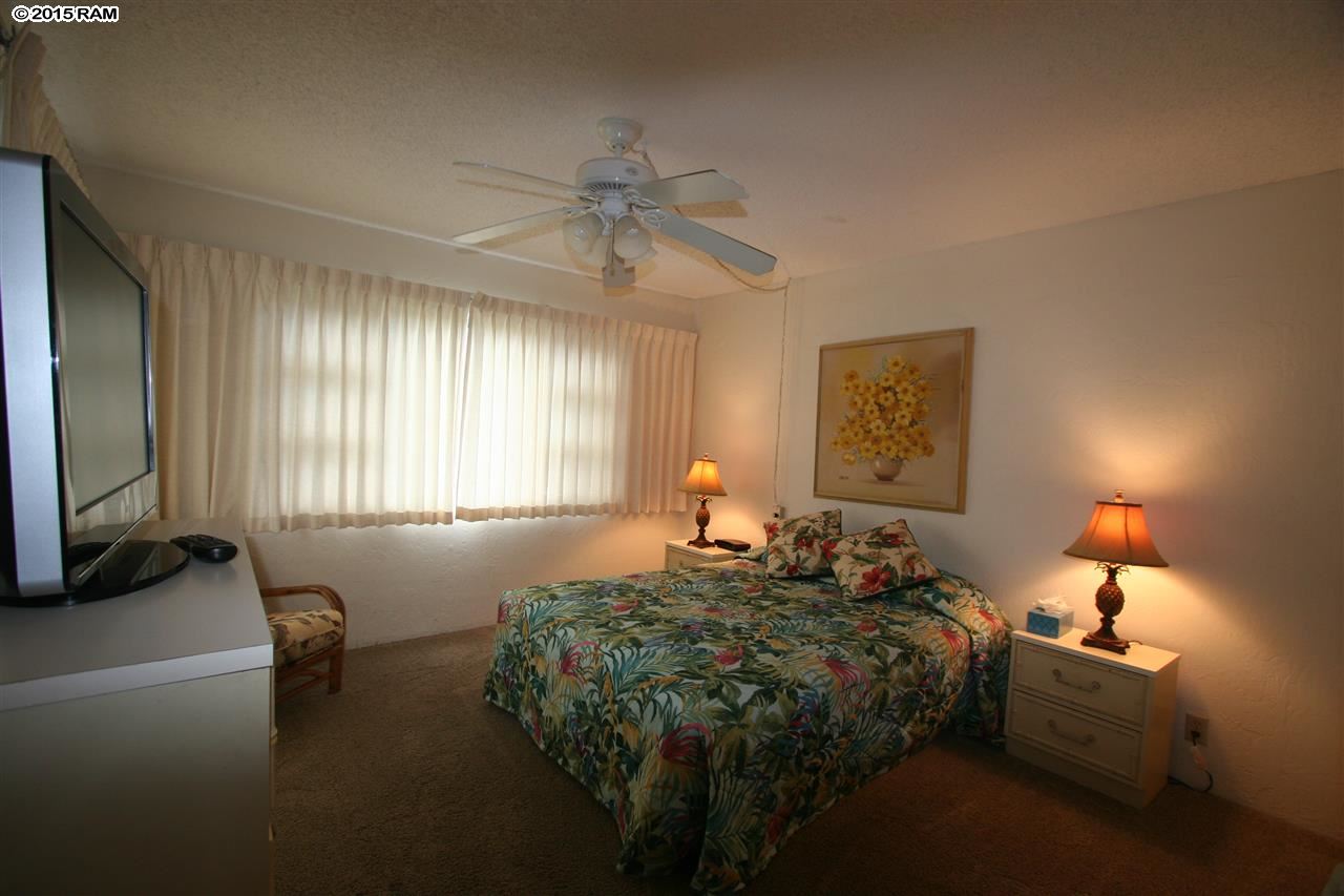 760 South Kihei Road, Unit 507 Kihei, HI 96753 - Photo 8 of 15 a bed room with a bed window and a flat screen tv