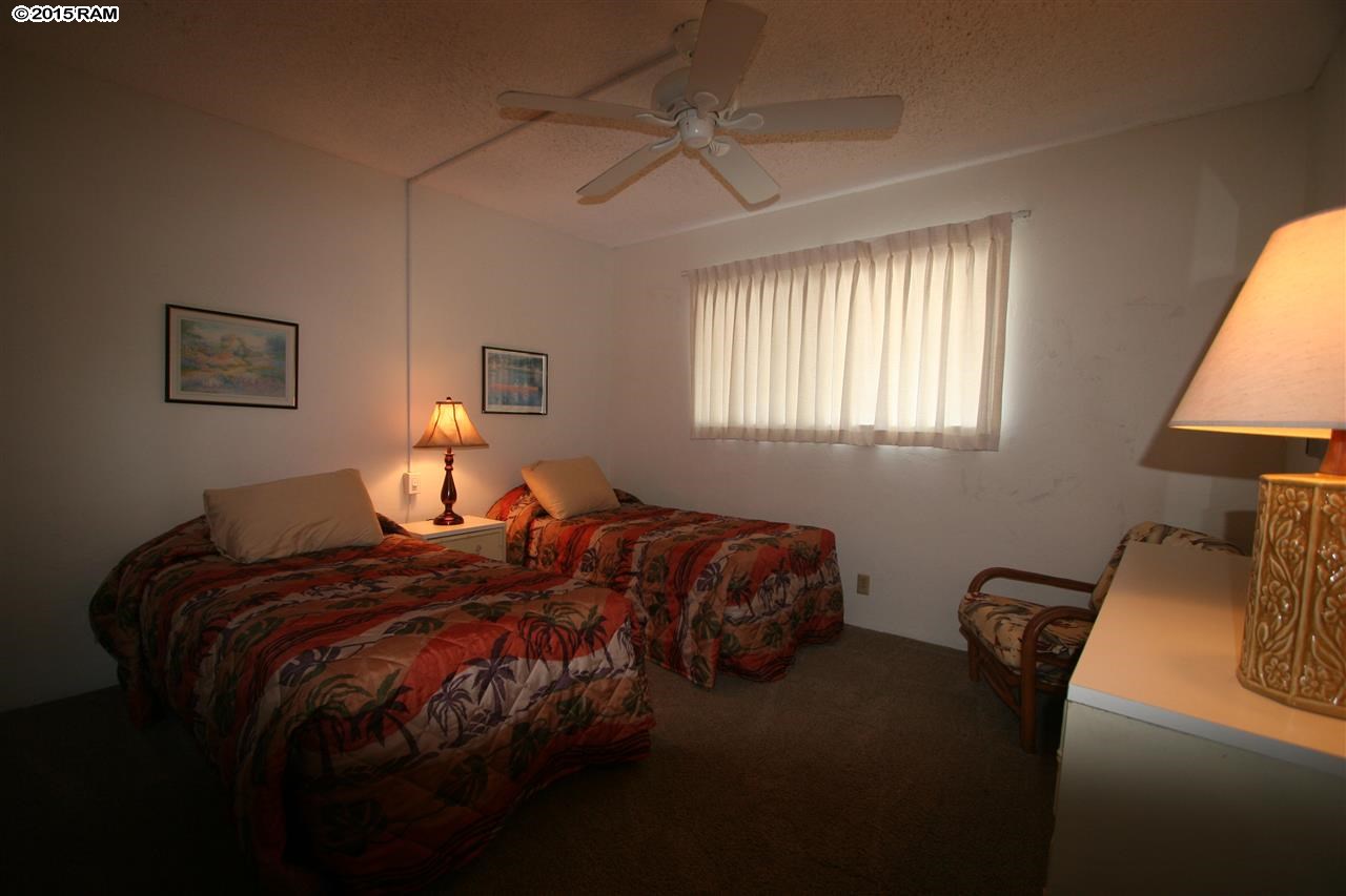 760 South Kihei Road, Unit 507 Kihei, HI 96753 - Photo 9 of 15 a bedroom with a bed and a lamp