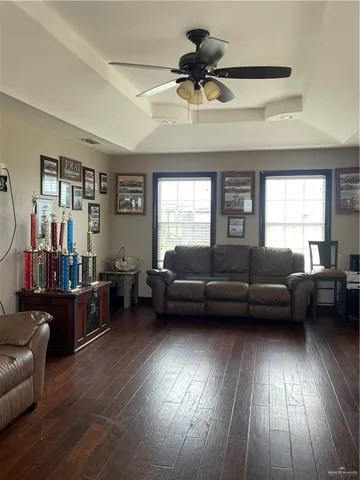 a living room with furniture and a wooden floor