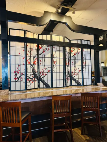 a dining room with furniture window and wooden floor