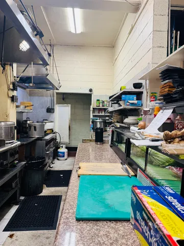 a stove top oven sitting inside of a kitchen