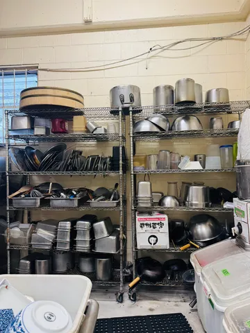 a kitchen with stainless steel appliances kitchen island granite countertop a refrigerator and a stove