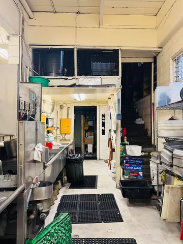 a room with stainless steel appliances kitchen island granite countertop a sink and cabinets