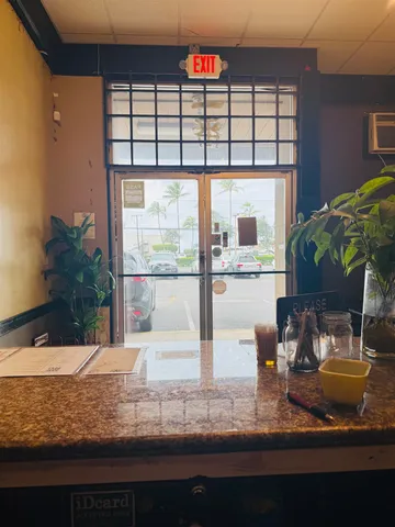 a room with pool table and a potted plant