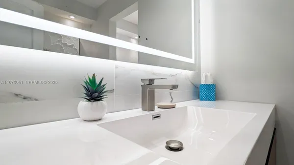 a bathroom with a sink and a mirror