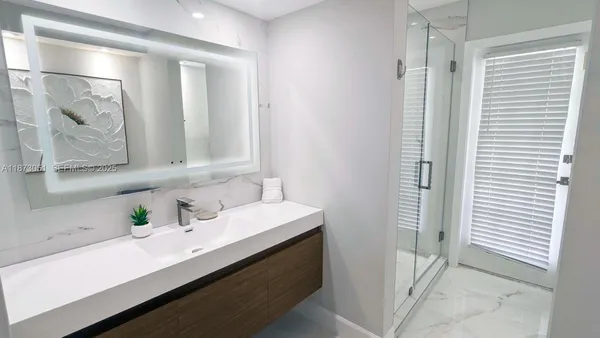 a bathroom with a sink and a mirror