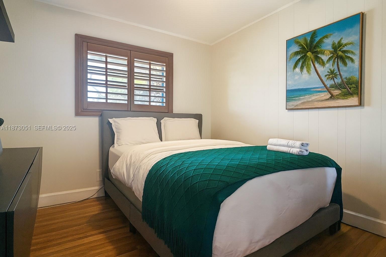 4027 Pierce Street Hollywood, FL 33021 - Photo 15 of 22 a bedroom with a bed and a painting on the wall