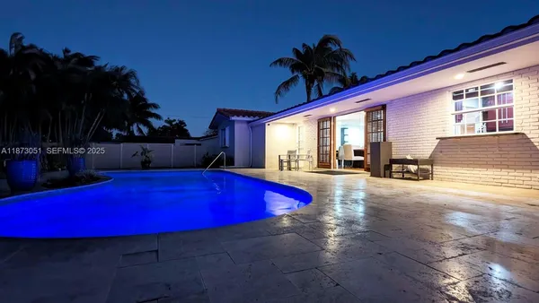 a swimming pool with lawn chairs with wooden floor