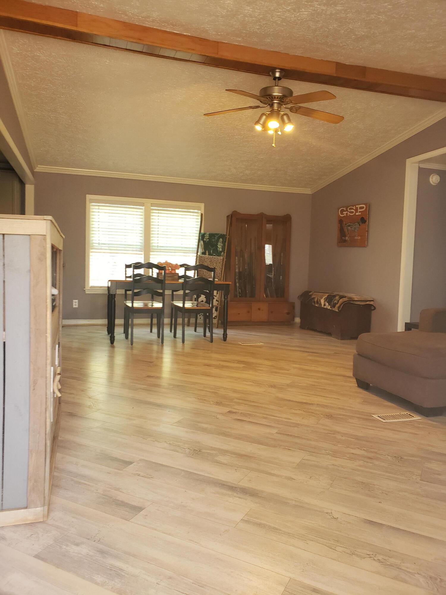 1910 Morris Road Goodview, VA 24095 - Photo 3 of 23 a dining room with furniture a chandelier and wooden floor