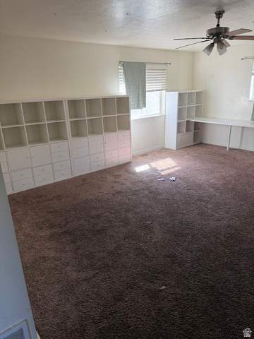 695 West 760 South Logan, UT 84321 - Photo 5 of 5 Unfurnished bedroom with carpet, a textured ceiling, and a ceiling fan