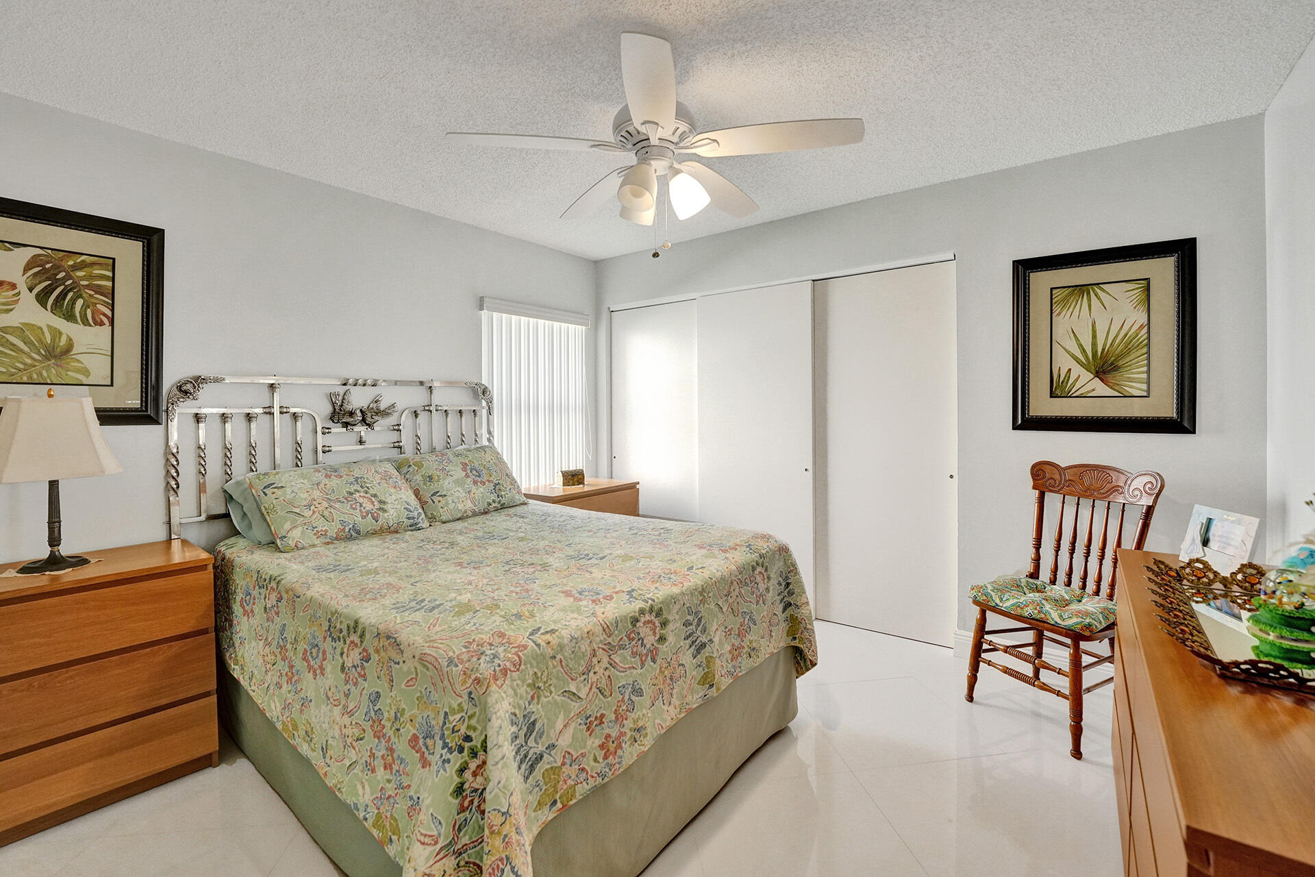 5447 Helene Circle Boynton Beach, FL 33472 - Photo 26 of 40 a bedroom with a bed and a chandelier