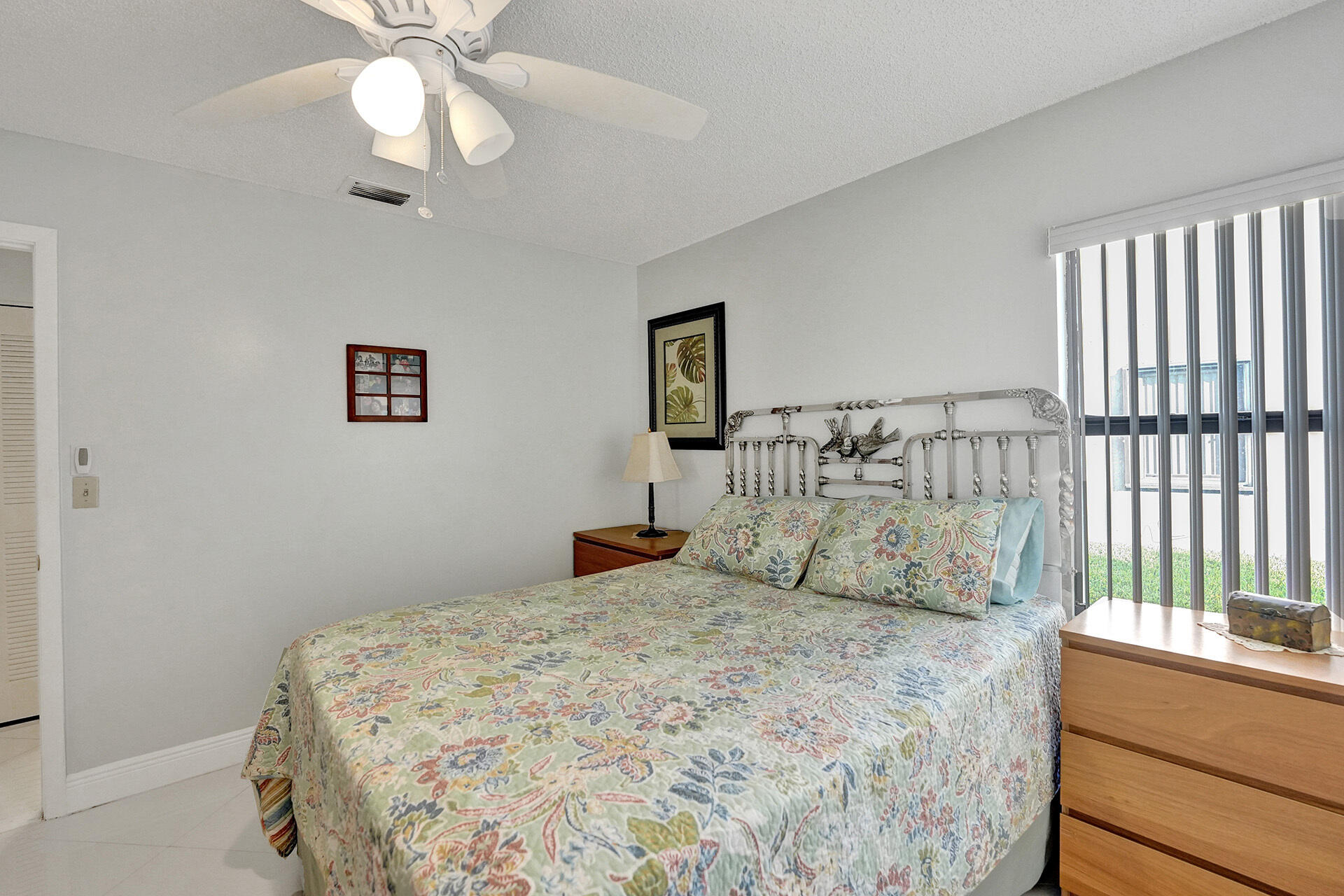 5447 Helene Circle Boynton Beach, FL 33472 - Photo 29 of 40 a bedroom with a large bed and a chandelier
