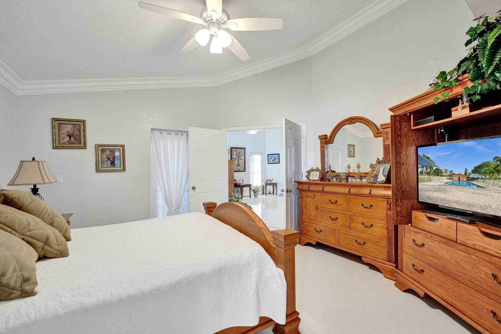 5447 Helene Circle Boynton Beach, FL 33472 - Photo 31 of 40 a bed room with a bed and a television