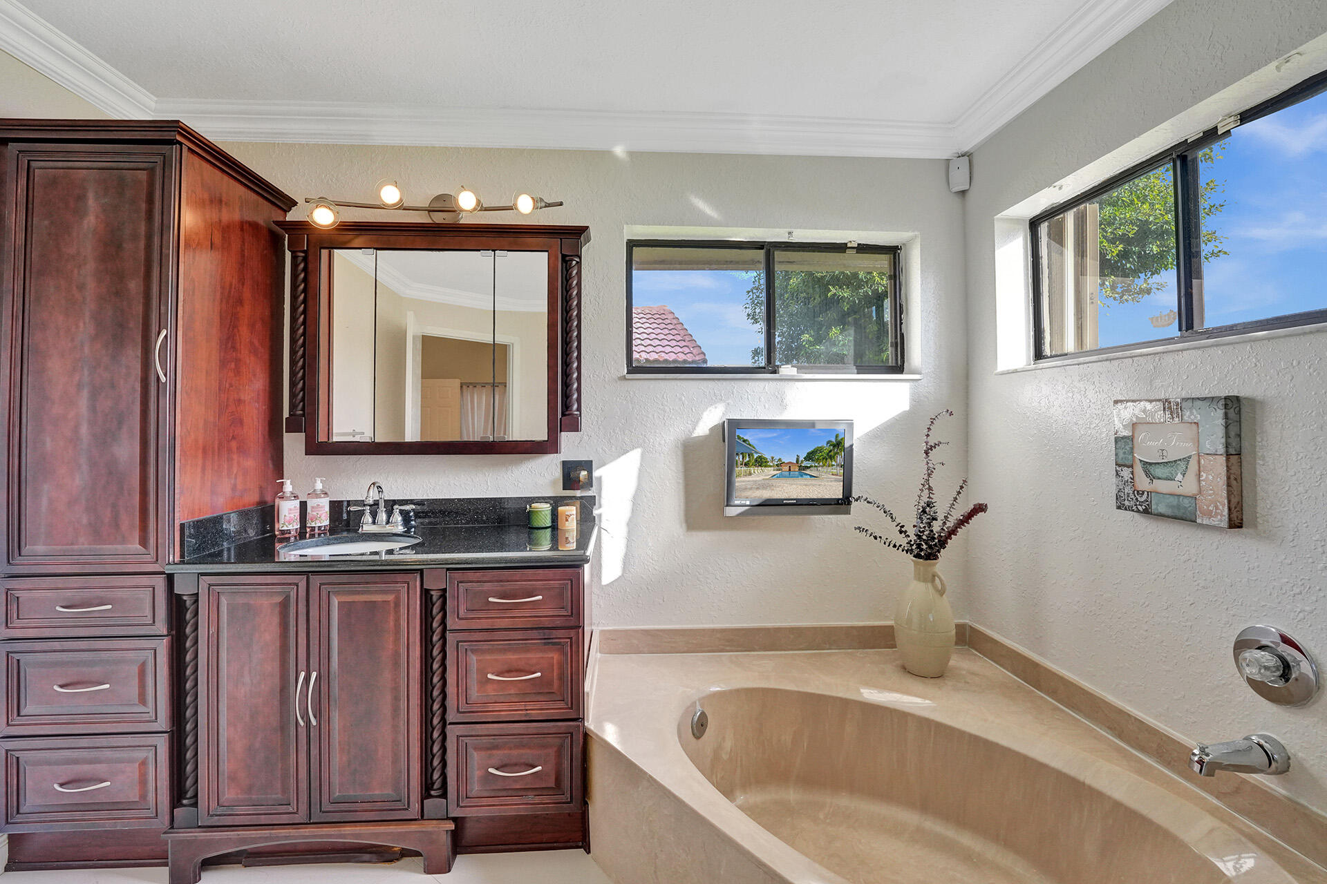 5447 Helene Circle Boynton Beach, FL 33472 - Photo 36 of 40 a bathroom with a tub sink and mirror