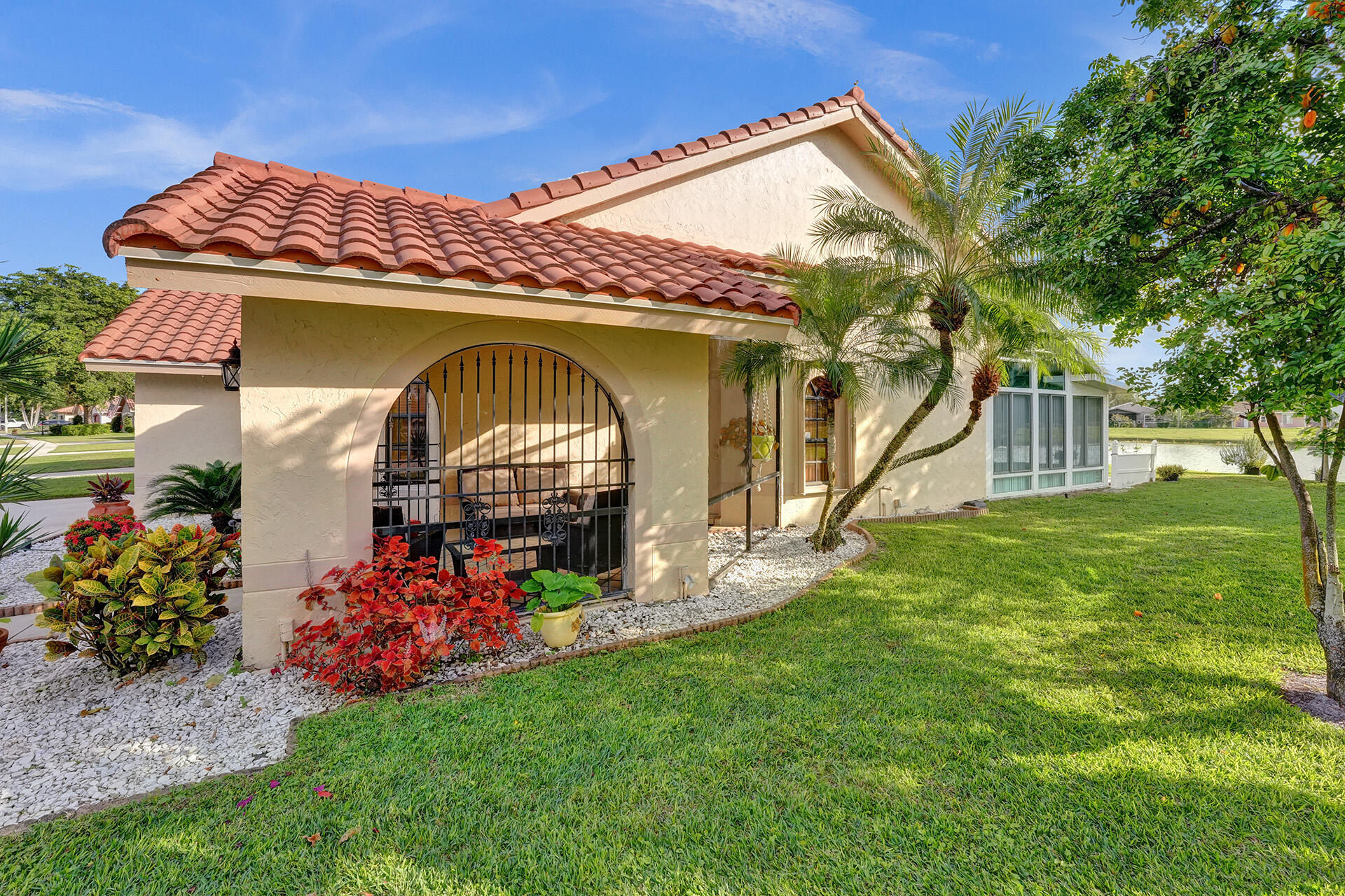 5447 Helene Circle Boynton Beach, FL 33472 - Photo 4 of 40 a front view of a house with garden