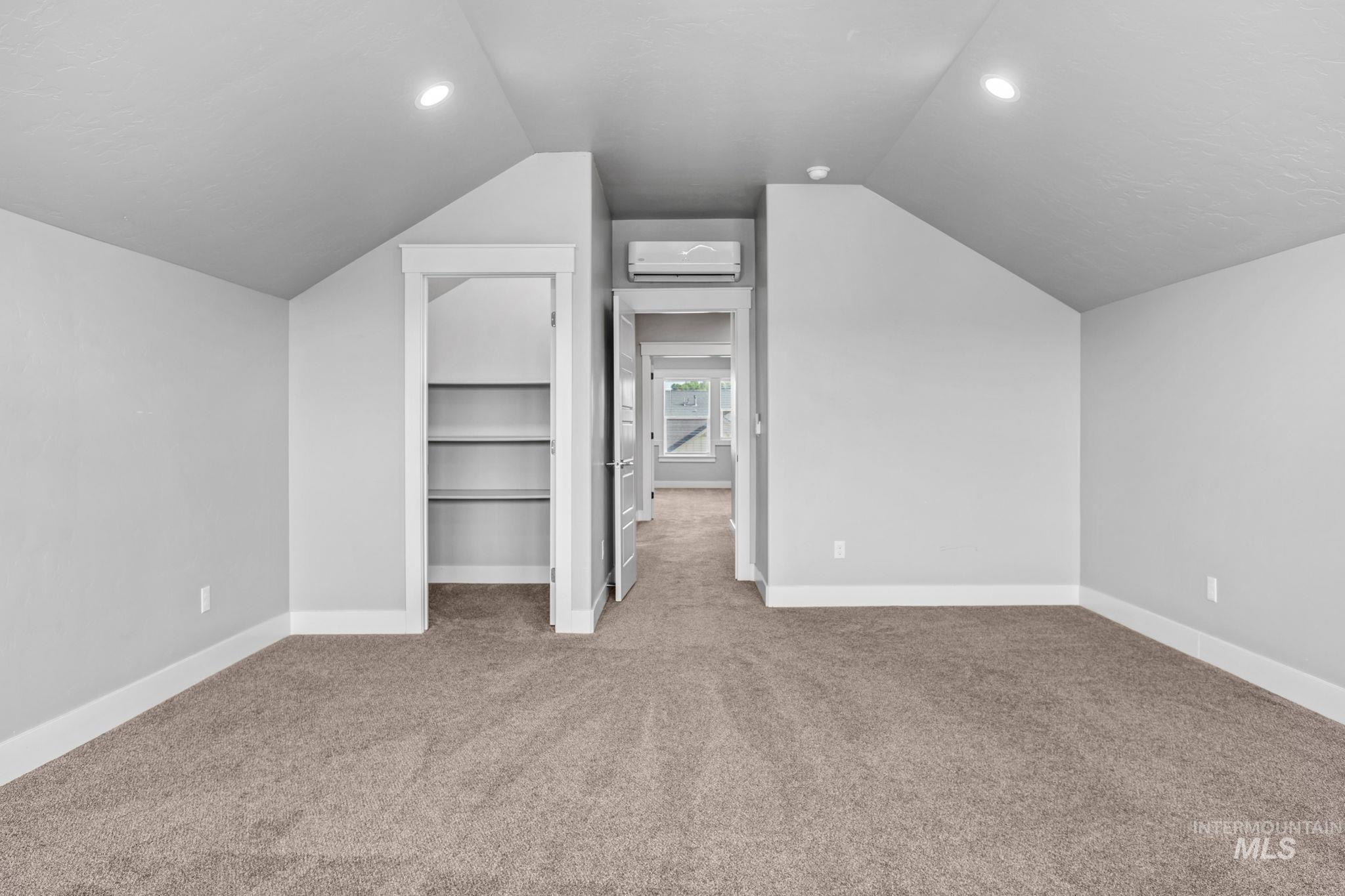 2934 East Murchison Street Meridian, ID 83642 - Photo 38 of 44 Carpeted room featuring sloped ceilings, recessed lighting, built-in shelving, and a wall-mounted mini-split unit