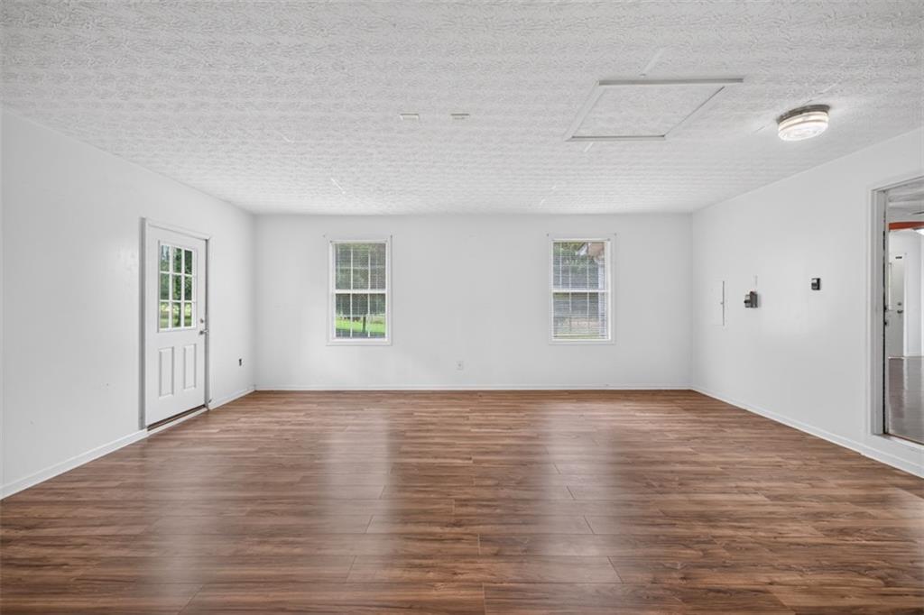 602 Pendergrass Road Winder, GA 30680 - Photo 33 of 44 a view of an empty room with wooden floor and a window