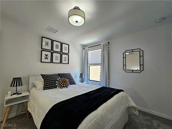 a bedroom with a bed and window