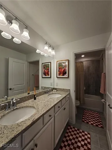 a bathroom with a granite countertop sink a mirror and a shower