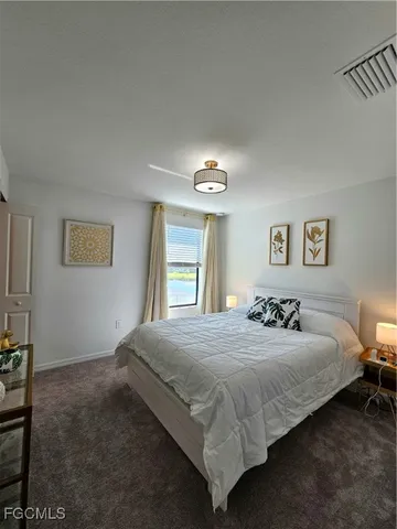 a bedroom with a bed and a night stand