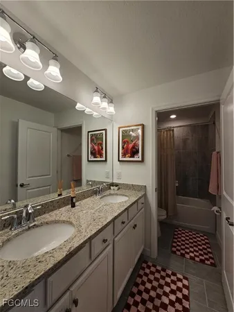 a bathroom with a granite countertop sink a mirror and a shower