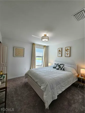 a bedroom with a bed and a night stand