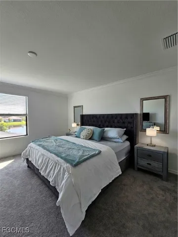 a bedroom with bed and window