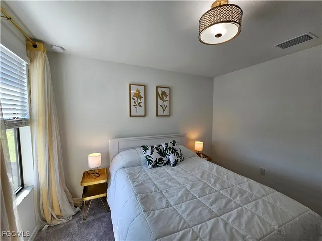 a bedroom with bed and window