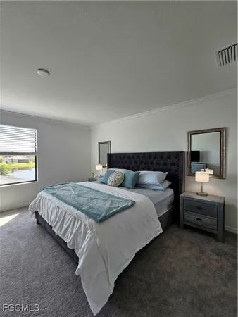 a bedroom with bed and window