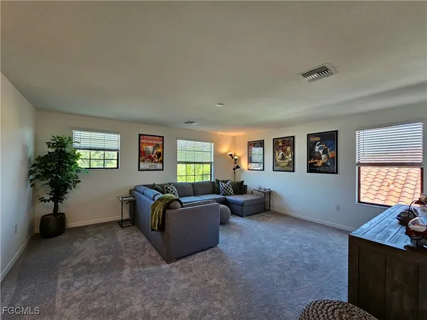 a living room with furniture window and potted plant