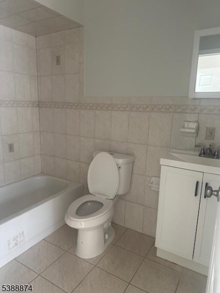 74 Kenmore Avenue, Unit 2 Newark, NJ 07106 - Photo 4 of 6 a white toilet sitting next to a bath tub and a sink