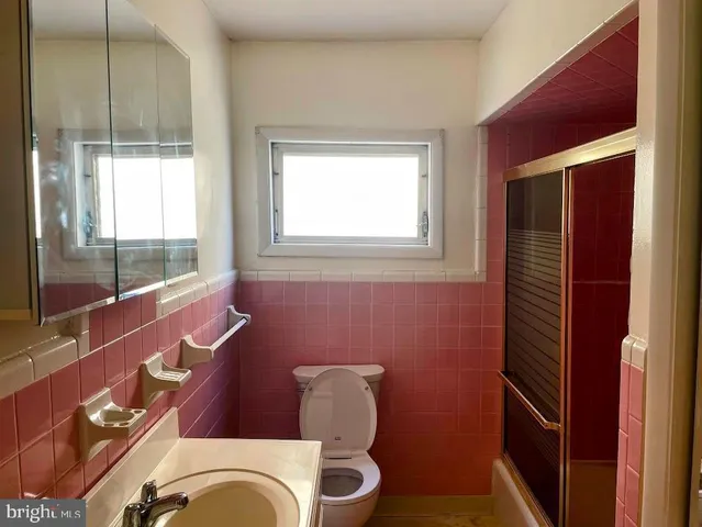a bathroom with a toilet bathtub and sink