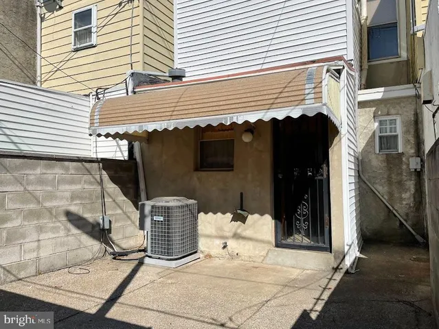 a side view of a house with a patio