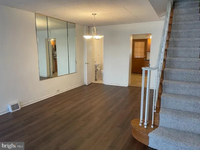 a view of a room with wooden floor and staircase