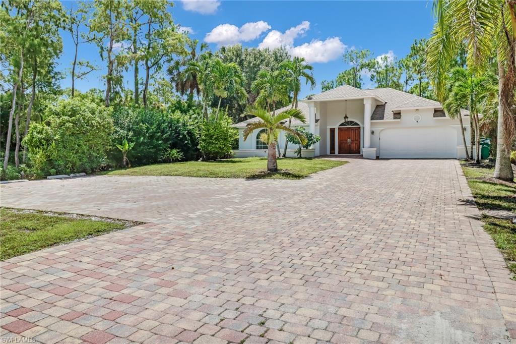 a front view of a house with a yard and a garage