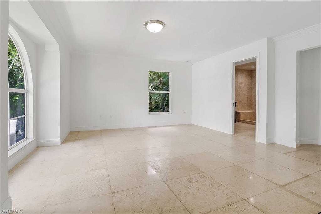 4540 Pine Ridge Road Naples, FL 34119 - Photo 17 of 30 an empty room with windows and closet